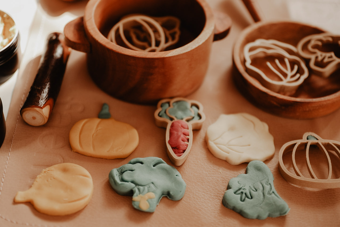 Kinfolk Pantry eco vegetable shaped playdough cutters. A pretend kitchen has been set up and the vegetable playdough shapes created have been added to the pots and pans.